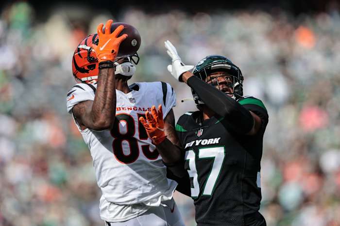 Oct 31, 2021; East Rutherford, New Jersey, USA; Cincinnati Bengals wide receiver Tee Higgins (85) catches the ball as New York Jets cornerback Bryce Hall (37) defends during the first half at MetLife Stadium.